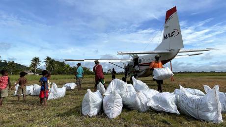 Unloading mosquito net bales at Edwaki