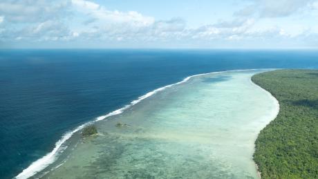 Ocean waves can be seen meeting the edge of Wuvulu.