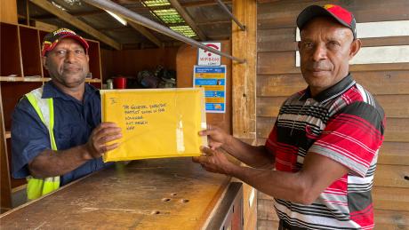 Mr Imit consigns CHW certificates at Telefomin base with one of our Traffic Officers