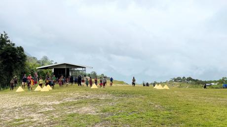 Bak airstrip clouded in, with people standing around watching...