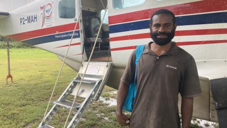 Job Tom posing in front of MAF plane