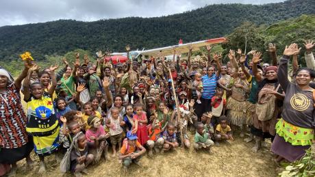 people of Yakona posing in front of the MAF plane for a group picture