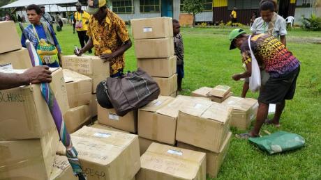 Boxes full of Bilum Books delivered by MAF being sorted.