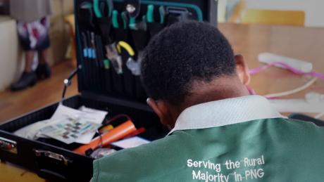 A participant back view while the background shows his tool kit.