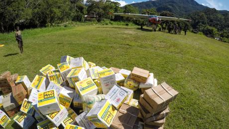 Cargo on an airstrip near a plane