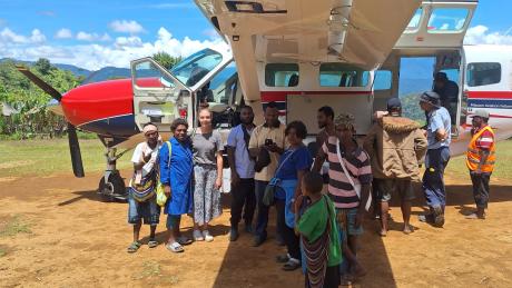 Kompiam health patrol team infront of the MAF plane