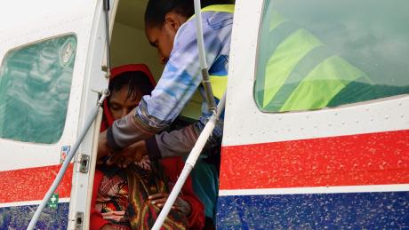 Patient being boarded on a MAF plane