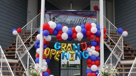 Balloons and a sign saying 'Grand Opening'