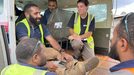 Bridget training a group of ground ops staff while in the MAF aircraft
