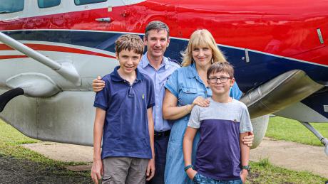 The Symmonds family in front of a C208 MAF plane.