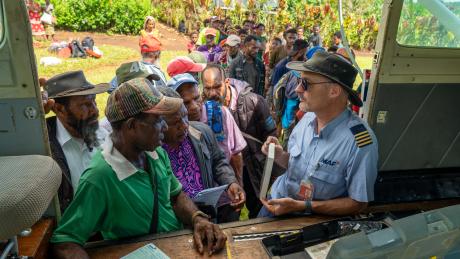 A pilot sells Bibles from the back of a small plane