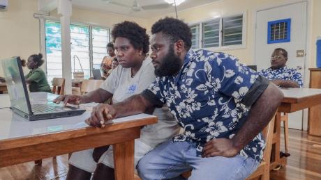 BCT Buka participants working hands-on with a computer during the training session.