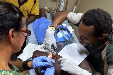 Susan Kopf and Yanis Keda operating a pig cut at Yifki