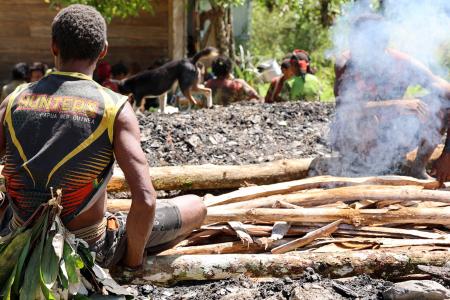 Yifki - people sitting at the mumu fire