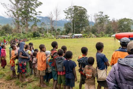 Villagers circle the runway upon the MAF plane's arrival.