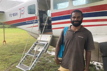 Job Tom posing in front of MAF plane