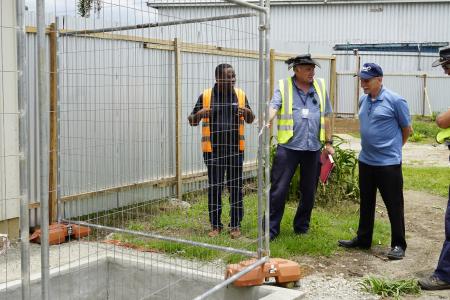Dave Moore (left middle) explaining the sewage system to MAFI CEO Dave Fyock (right middle), Regional Director Samuel Okposin (left), and Brad Venter (Chief Pilot).