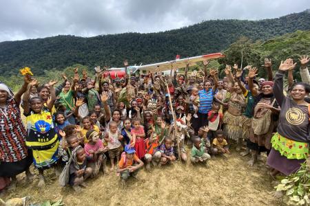 people of Yakona posing in front of the MAF plane for a group picture
