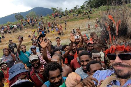 Captn Ryan Cole carried on the shoulders of the people after he landed the first MAF aircraft at Dimanbil