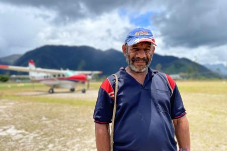 Ps Benard Nohsarin in front of a MAF aircraft at Telefomin