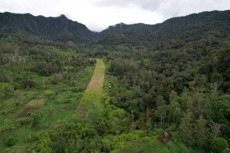A remote airstrip in Papua New Guinea in a valley 