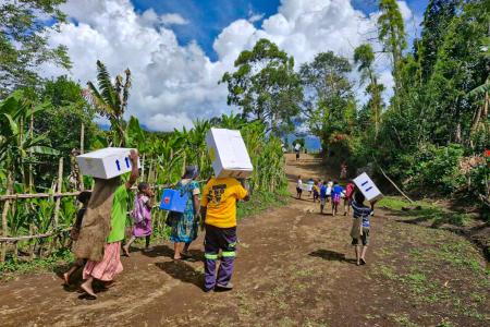 locals from remote Sindeni village carrying the mdical supplies to the health center