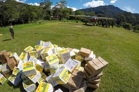 Cargo on an airstrip near a plane