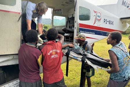 medevac patient on stretcher gets loaded into the aircraft
