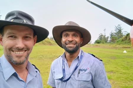 Brad Venter and Joseph Tua in front of MAF plane