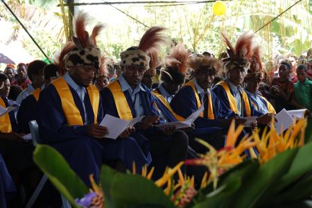Mougulu grade 12 graduates in their gowns and with traditional head dresses