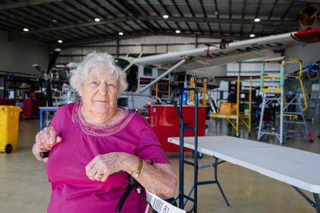 Elderly lady in aircraft hangar