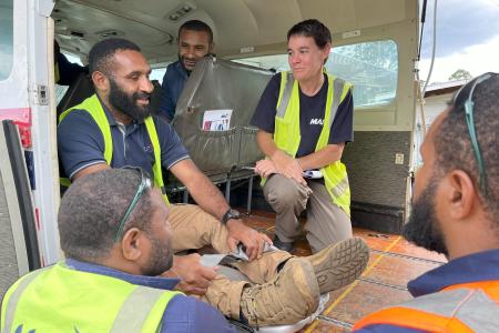 Bridget training a group of ground ops staff while in the MAF aircraft