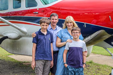 The Symmonds family in front of a C208 MAF plane.