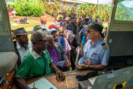 A pilot sells Bibles from the back of a small plane