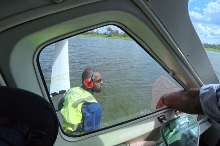 Titus Oaeke fastening the floatplane at docking station