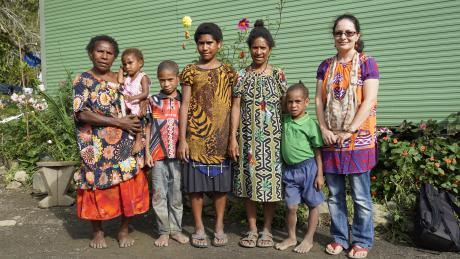 Group photo of Selah holding a toddler, Jesslyn and Richard and two others of her 4 children, and Bernadette Axon