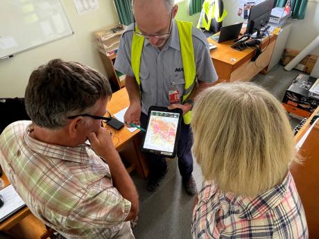 Pilot Mathias Glass showing the Dorricotts the flight route 