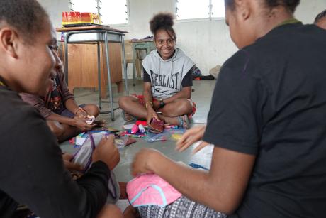 Elma Mambu sitting in the circle with other girls during the workshop