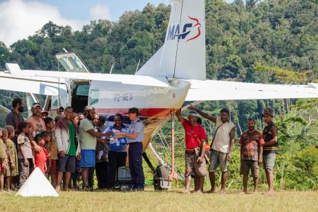 A pilot sells Bibles from the back of a small plane
