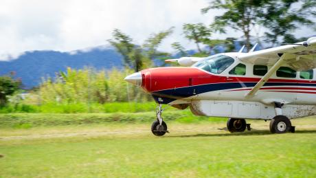 A plane takes off on a bush airstrip