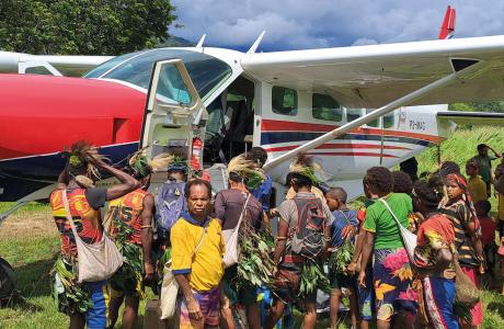 aircraft at Mengau airstrip surrounded bye local people