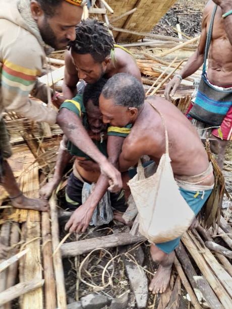 The man being pulled out from under his collapsed house