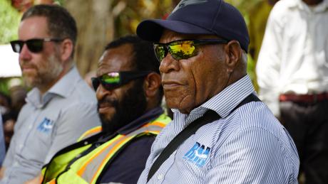 Michael Anggo listening to the speeches