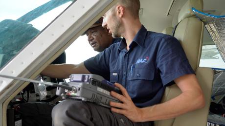 Samuel Dauth and Maro Kopi using the new equipment performing tests in the cockpit of a C208