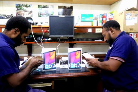 MAF Technologies, IT officers working on installing apps and software into the tablets for the wycliffe associates