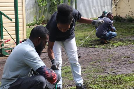 Male and female participant going through a session outdoor which they get to install a HF radio system.