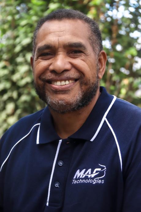 A medium shot of Caine Ruruk as he poses for a picture