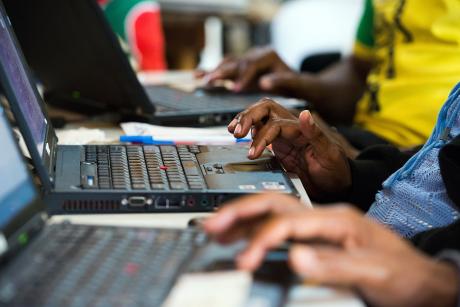 close up shot of hands working on laptops