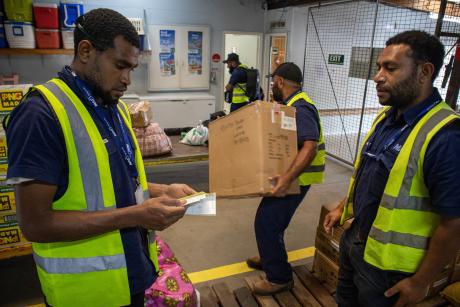 Staff prepare cargo for flight in a storeroom
