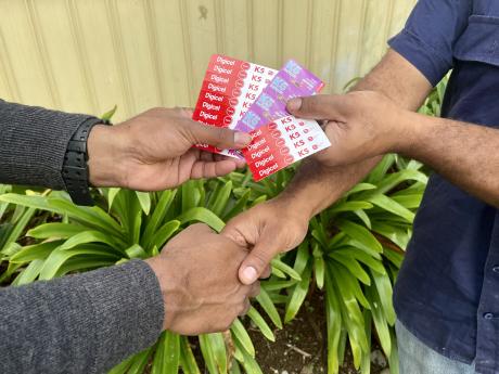 Phone credit tokens held in hands